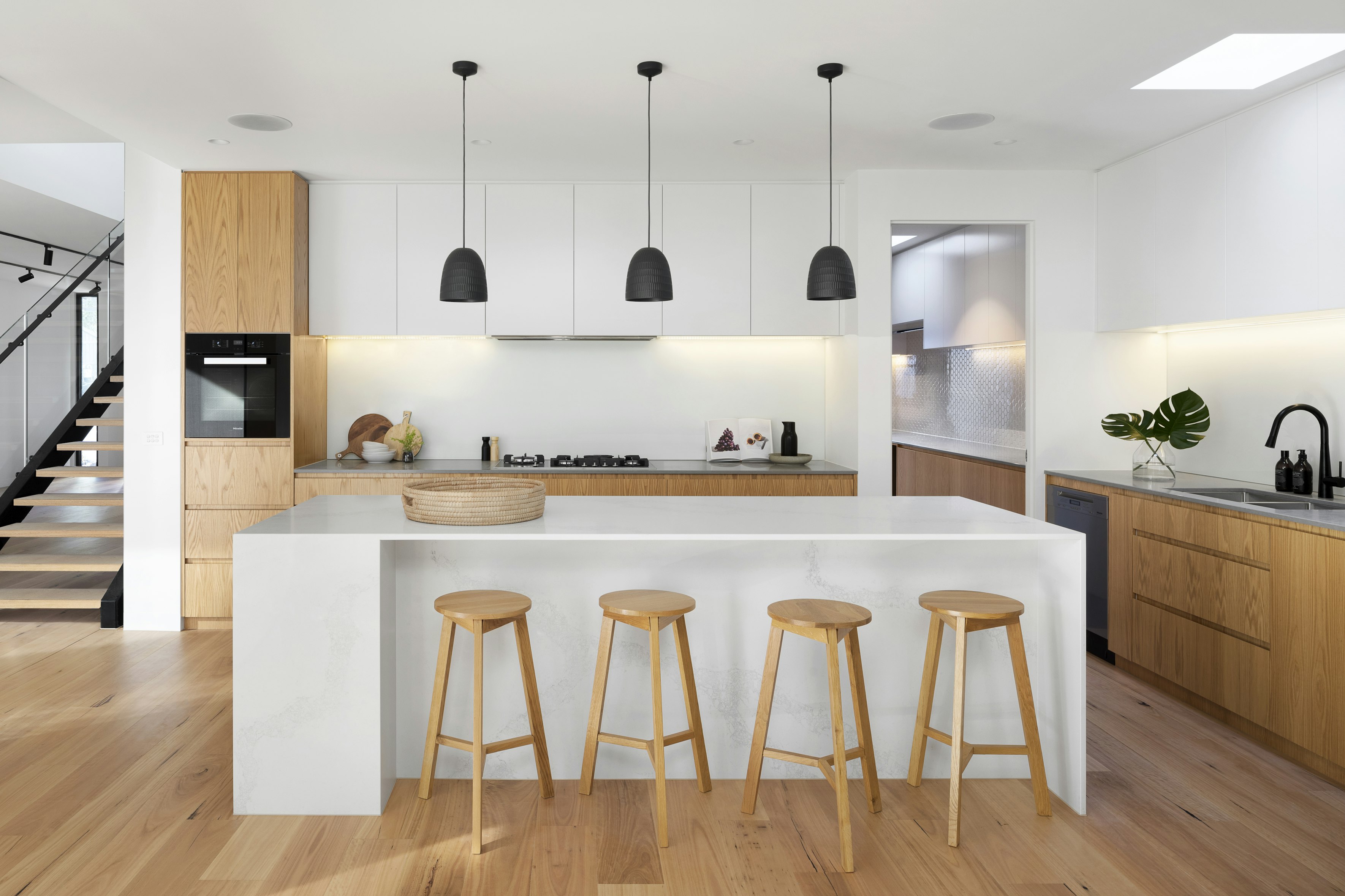 Modern home interior with warm seating and large windows